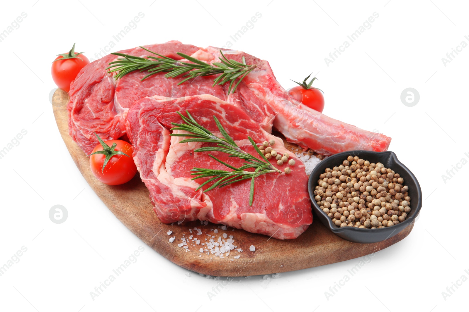 Photo of Pieces of raw beef meat, spices and tomatoes isolated on white