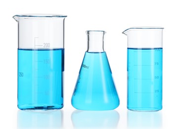 Photo of Laboratory glassware with blue liquid isolated on white