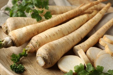 Photo of Raw parsley roots on table, closeup view