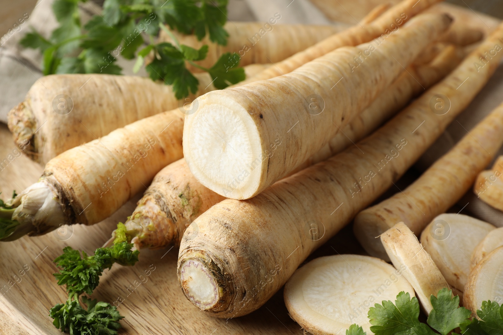 Photo of Raw parsley roots on table, closeup view