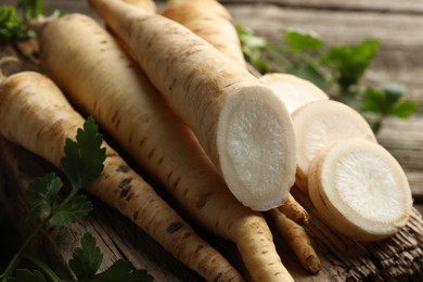 Photo of Parsley roots and leaves on table, closeup