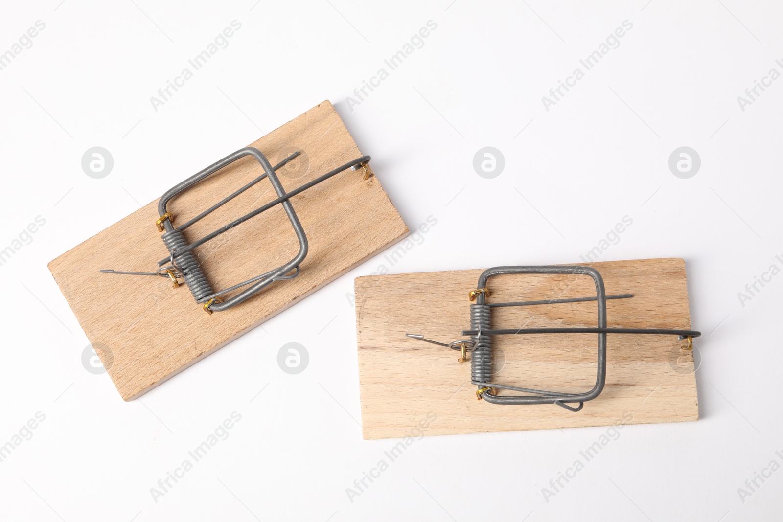 Photo of Two spring-loaded bar mousetraps isolated on white, top view