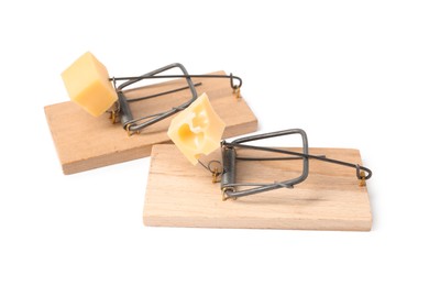 Photo of Two spring-loaded bar mousetraps with pieces of cheese isolated on white