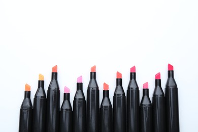 Photo of Many colorful markers on white background, top view