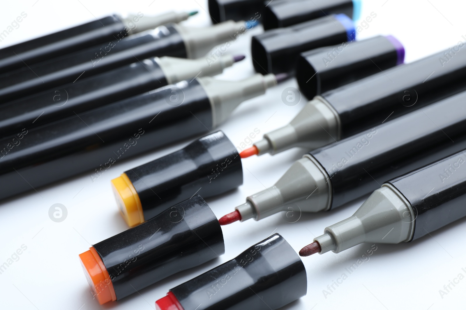 Photo of Many colorful markers on white background, closeup