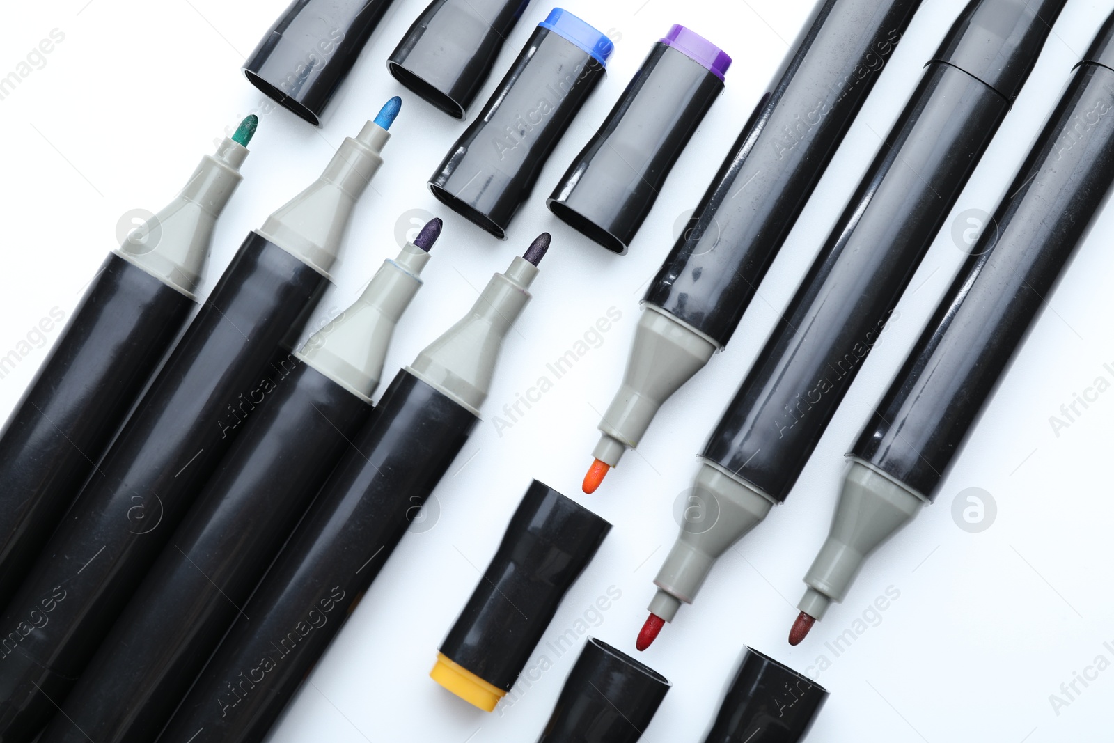 Photo of Many double sided markers on white background, top view