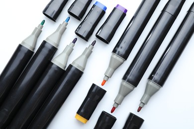 Photo of Many double sided markers on white background, top view