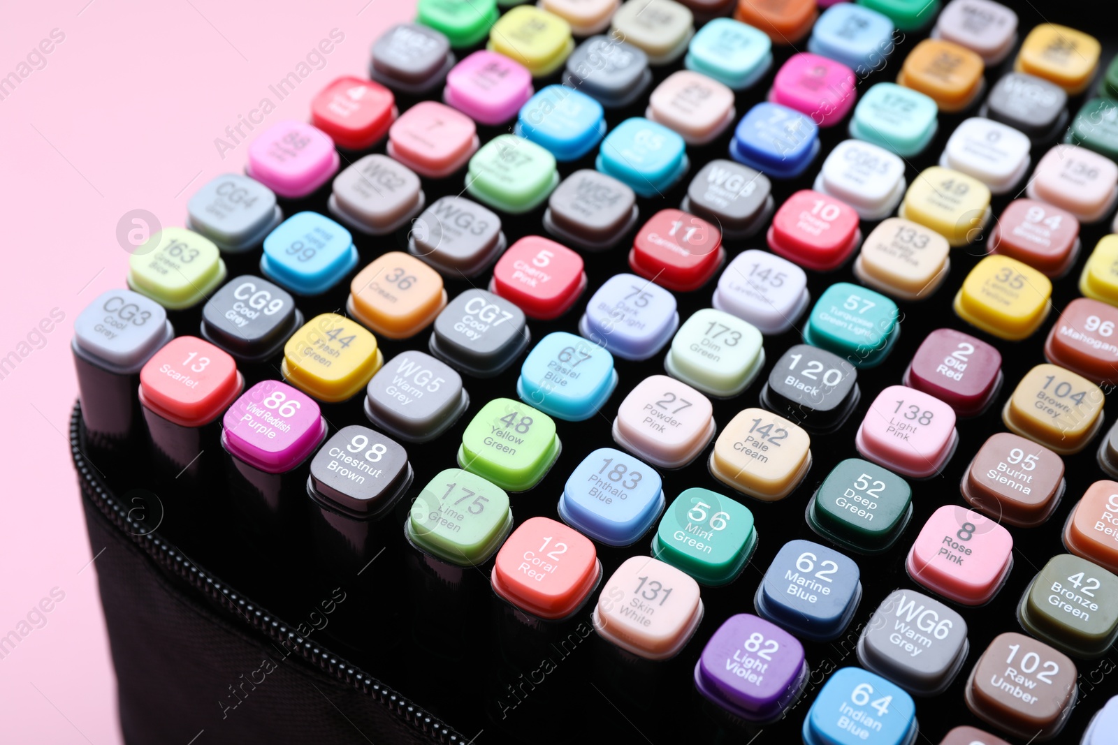 Photo of Many colorful markers in bag on pink background, closeup