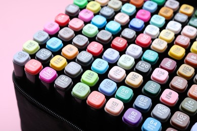 Photo of Many colorful markers in bag on pink background, closeup