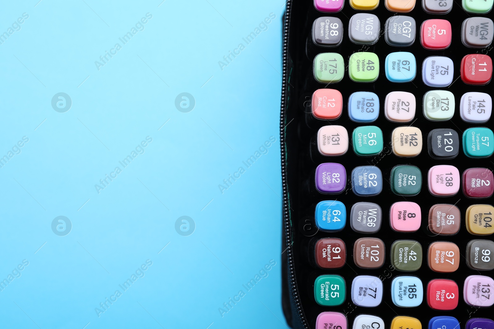 Photo of Many colorful markers in bag on light blue background, top view. Space for text