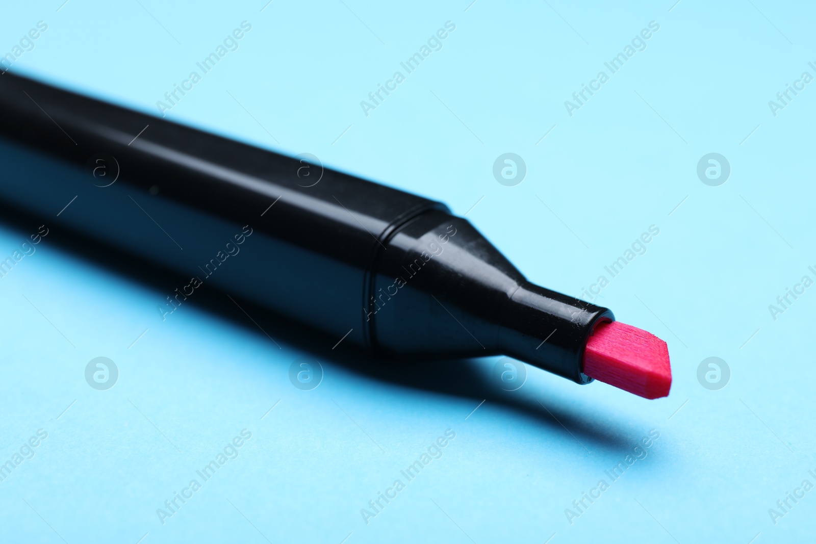 Photo of One color marker on light blue background, closeup