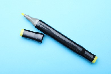 Photo of One double sided marker on light blue background, top view