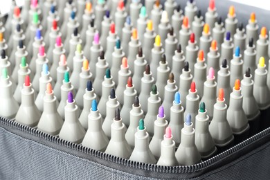 Photo of Many colorful markers in bag, closeup. Art supplies