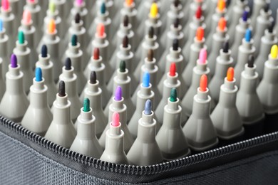 Photo of Many colorful markers in bag, closeup. Art supplies