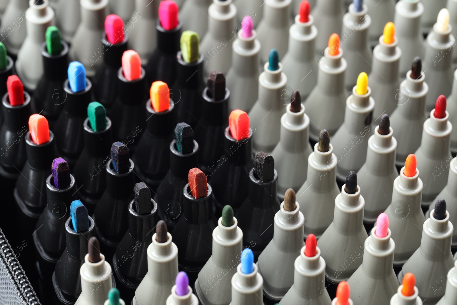 Photo of Many colorful markers in bag, closeup. Art supplies