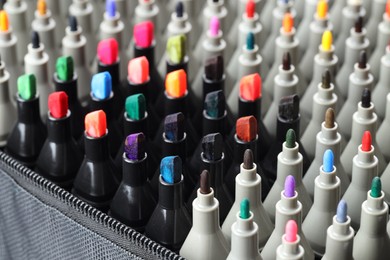 Photo of Many colorful markers in bag, closeup. Art supplies