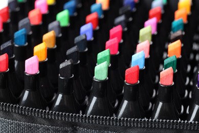 Photo of Many colorful markers in bag, closeup. Art supplies