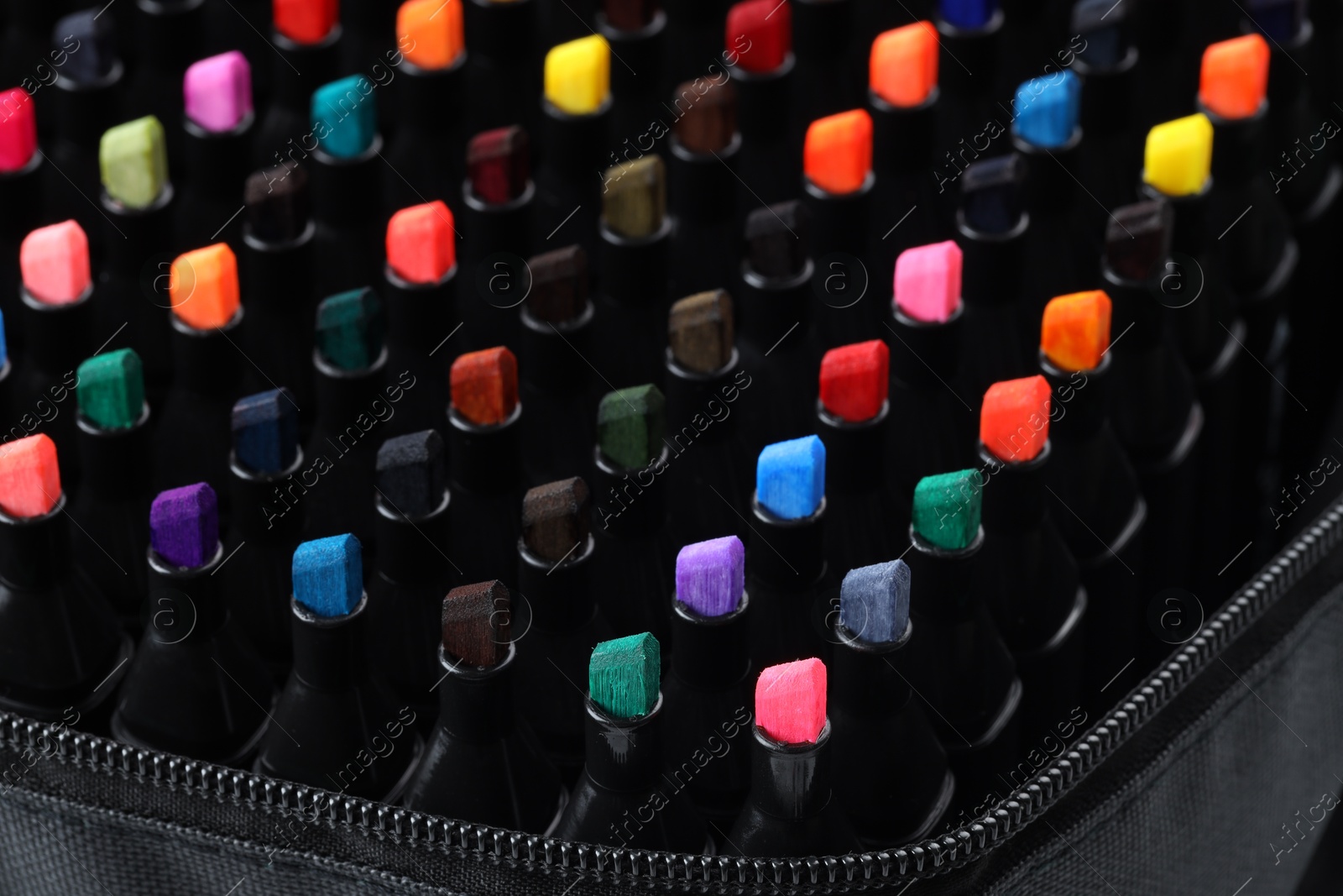 Photo of Many colorful markers in bag, closeup. Art supplies