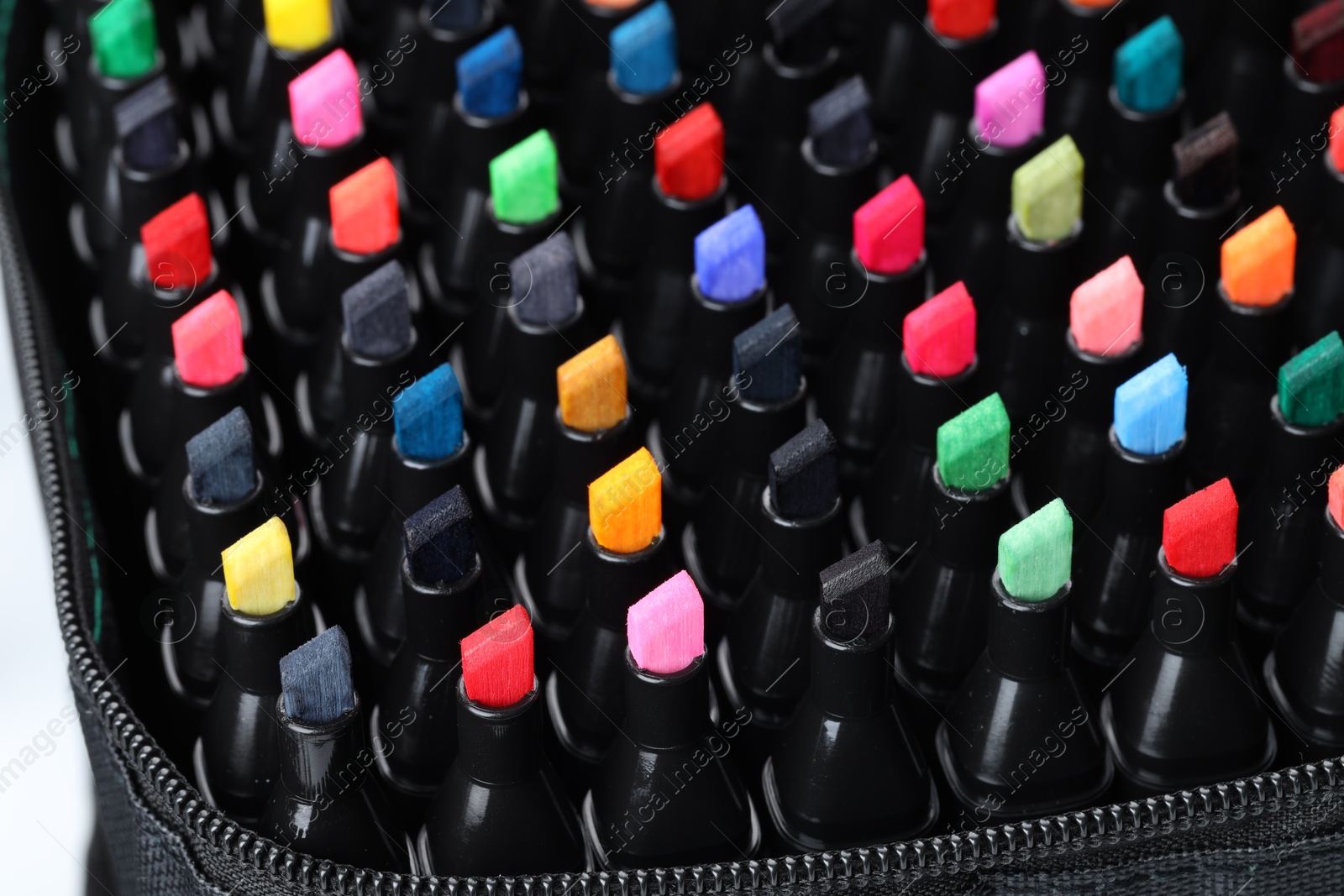 Photo of Many colorful markers in bag, closeup. Art supplies