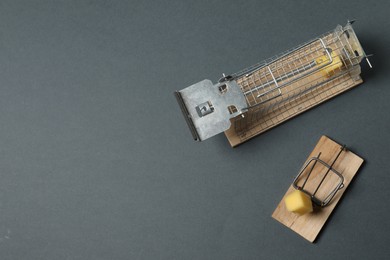 Photo of Two different mouse traps with bait on gray background, top view. Space for text