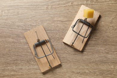 Photo of Two spring-loaded bar mousetraps on floor, flat lay