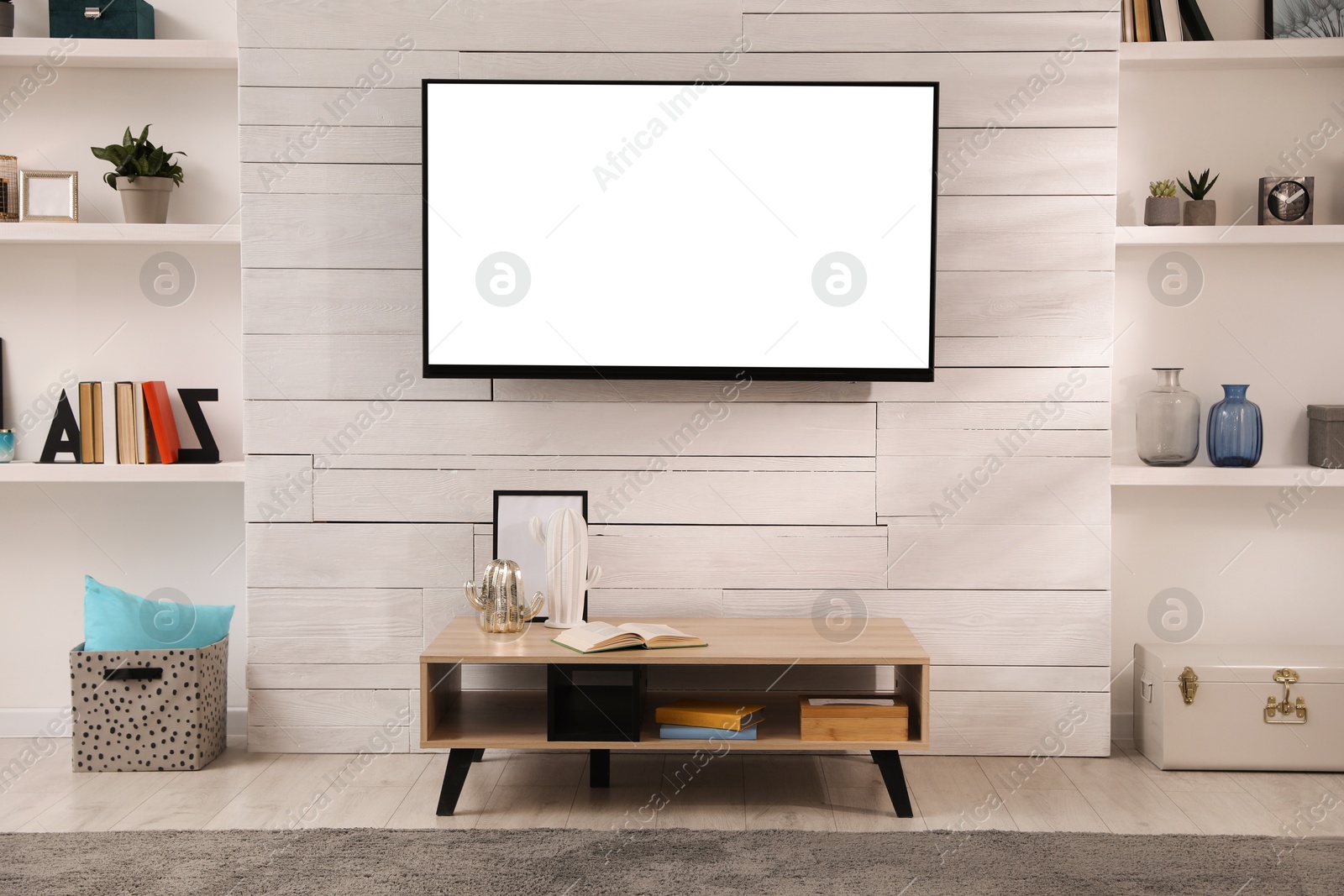 Image of Tv set with white screen mounted on wall in room. Mockup for design