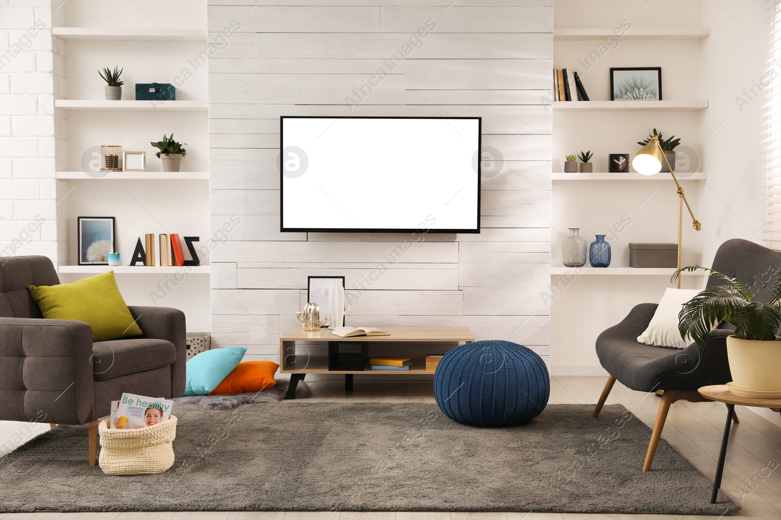 Image of Tv set with white screen mounted on wall in room. Mockup for design