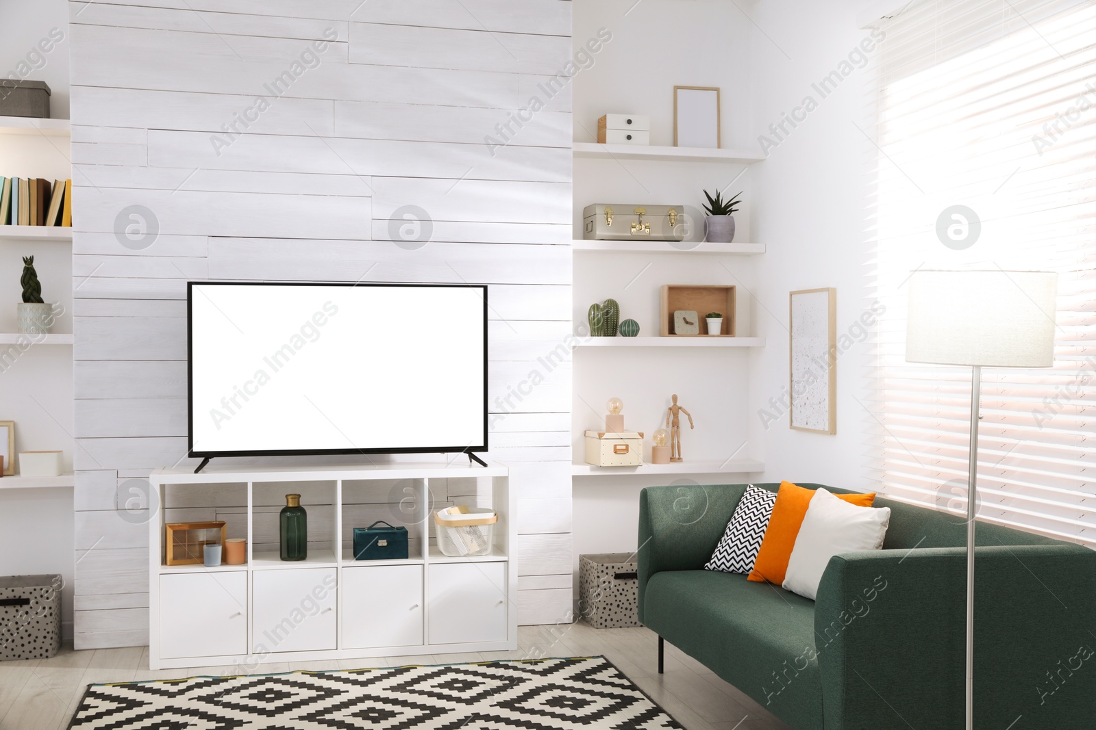 Image of Tv set with white screen on stand in room. Mockup for design