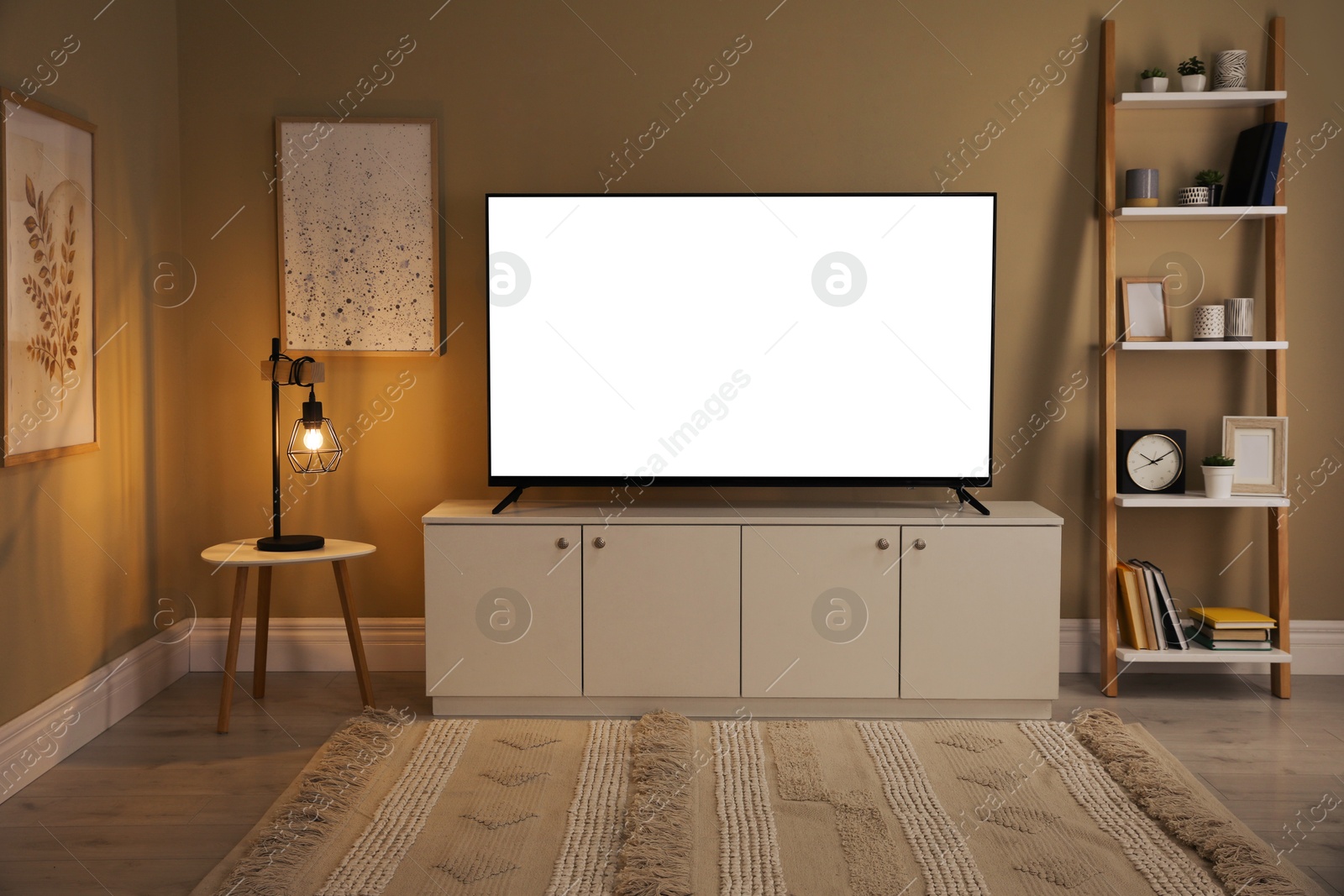 Image of Tv set with white screen on stand in room. Mockup for design