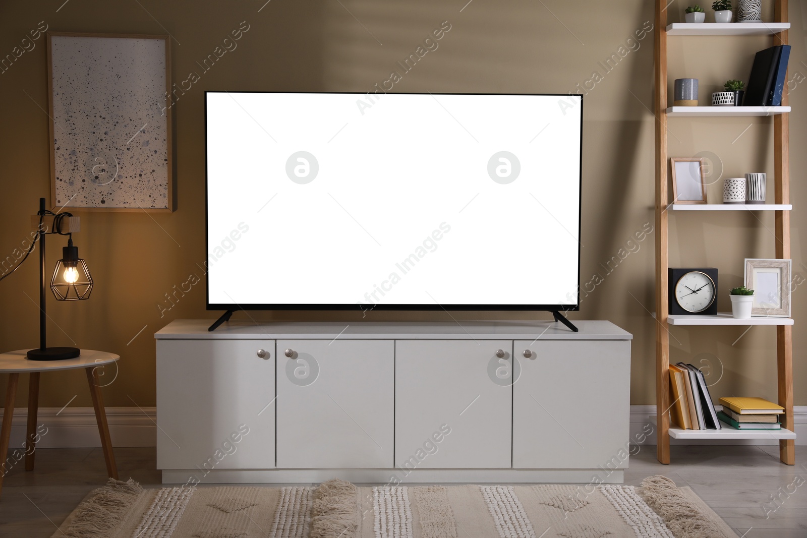 Image of Tv set with white screen on stand in room. Mockup for design