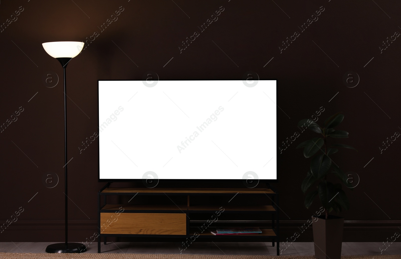 Image of Tv set with white screen on stand in room. Mockup for design