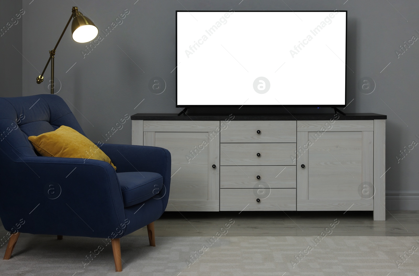 Image of Tv set with white screen on stand in room. Mockup for design