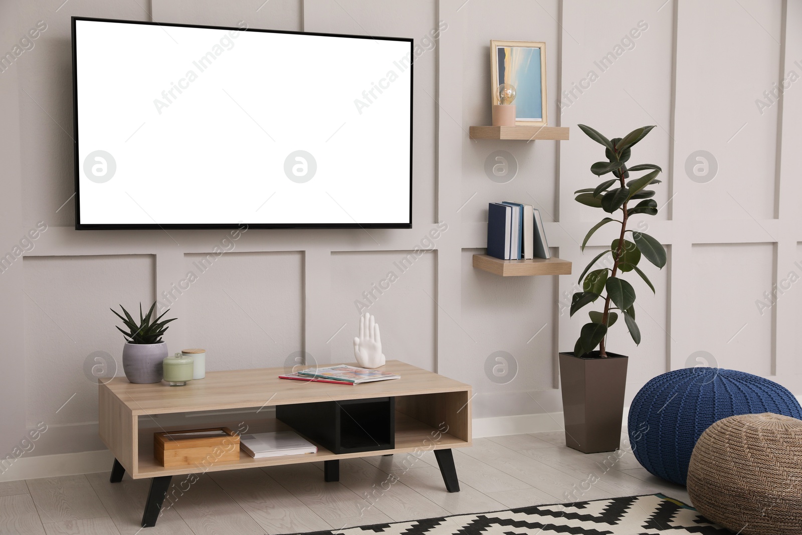 Image of Tv set with white screen mounted on wall in room. Mockup for design