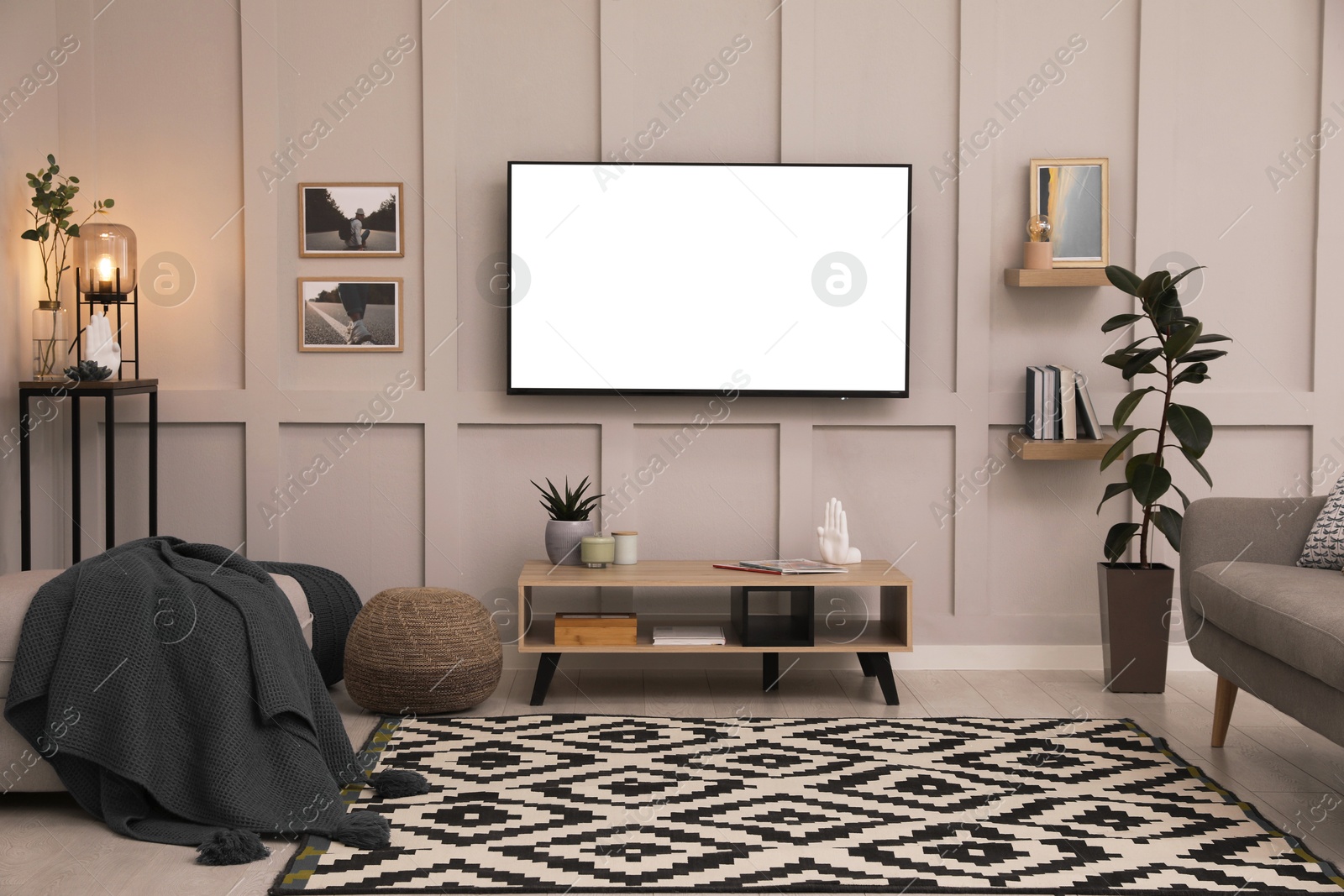 Image of Tv set with white screen mounted on wall in room. Mockup for design