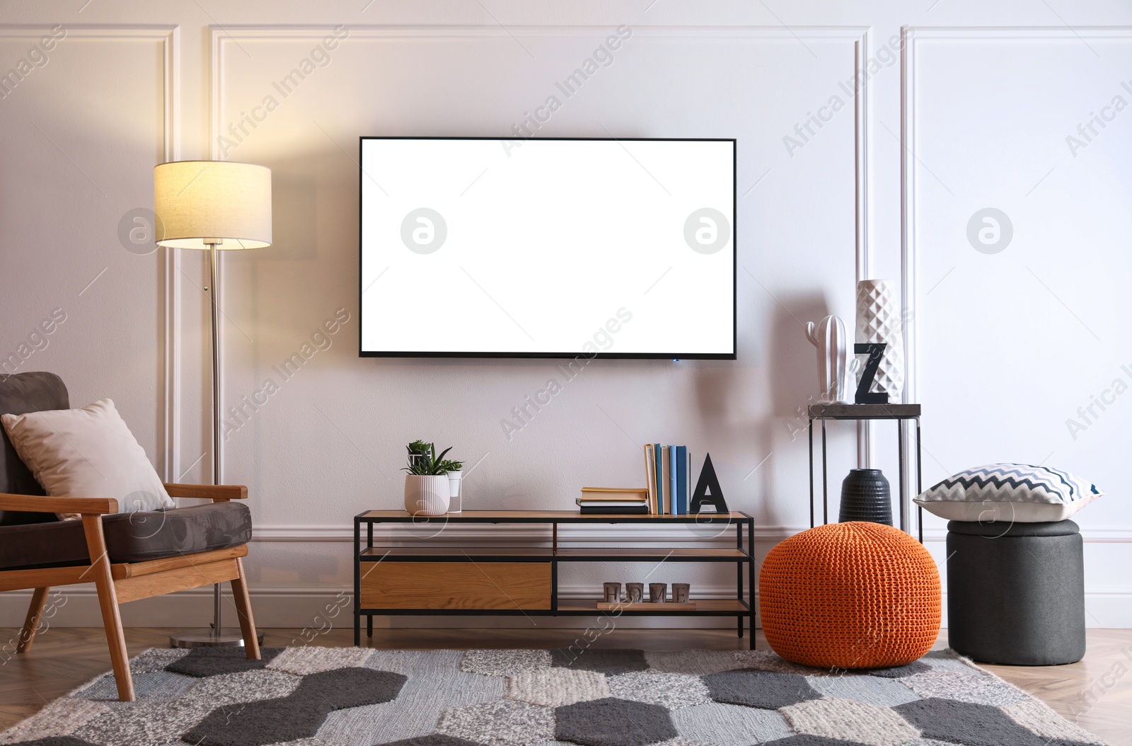 Image of Tv set with white screen mounted on wall in room. Mockup for design