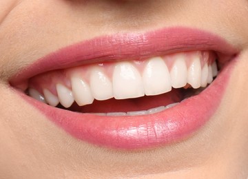 Young woman with healthy teeth and beautiful smile, closeup