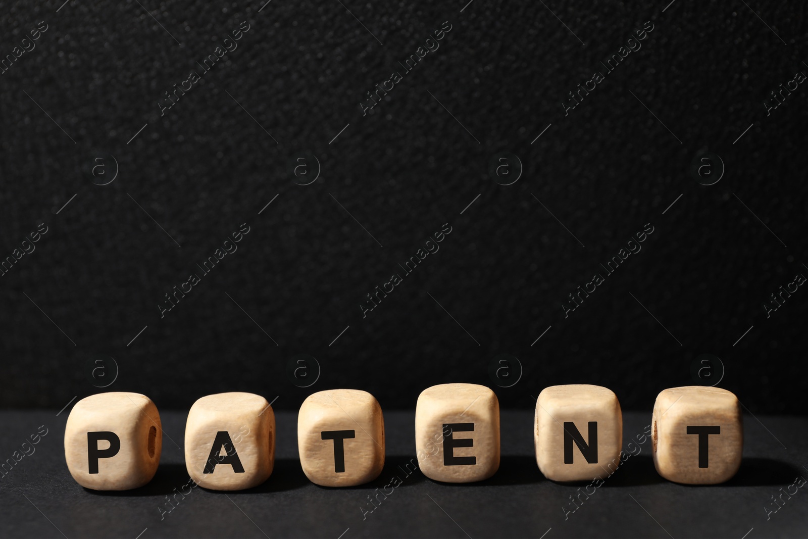 Image of License. Word Patent made of wooden cubes with letters on black table