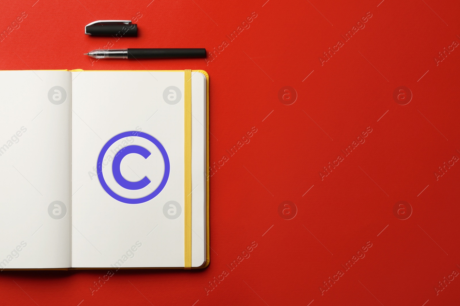 Image of License. Notebook with copyright symbol and pen on red background, top view