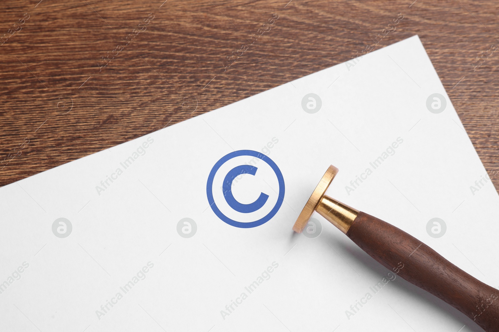 Image of License. Paper with copyright symbol stamp and tool on wooden table, top view