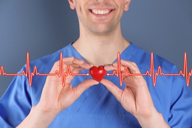 Cardiology. Doctor holding red decorative heart on color background, closeup. Red heartbeat line