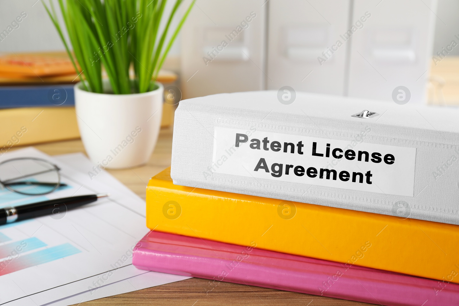 Image of File folder with Patent License Agreement label on table, closeup