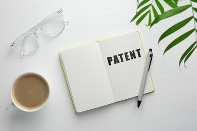 Image of License. Word Patent in notebook, eyeglasses, pen and coffee on white wooden table, flat lay