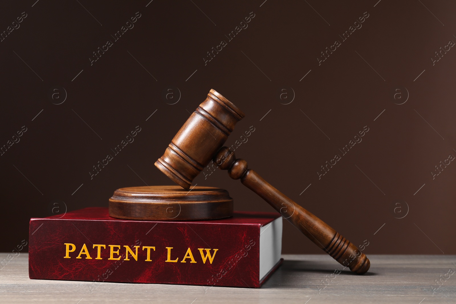 Image of License. Patent law book and judge's gavel on wooden table