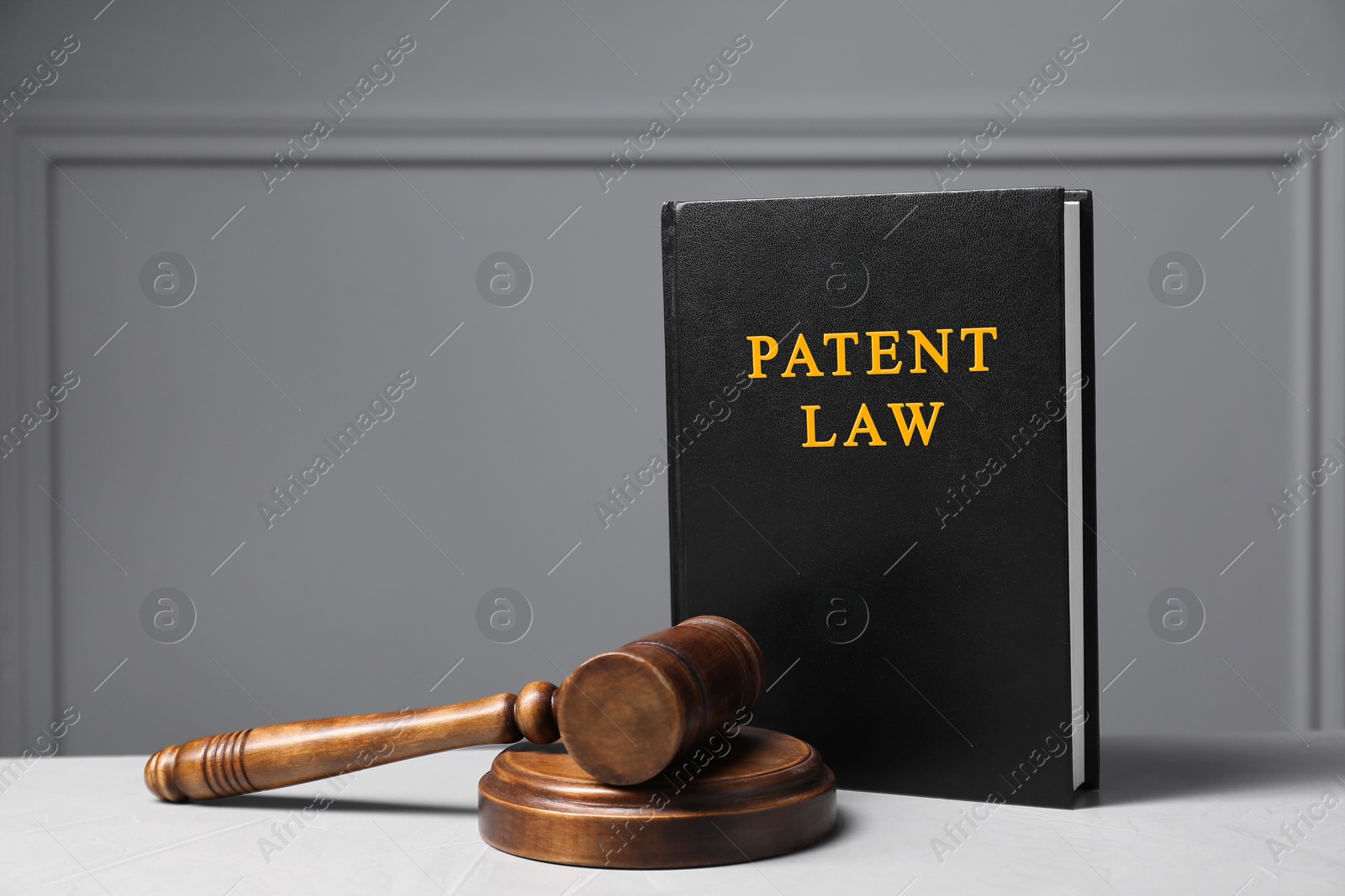 Image of License. Patent law book l and judge's gavel on white table