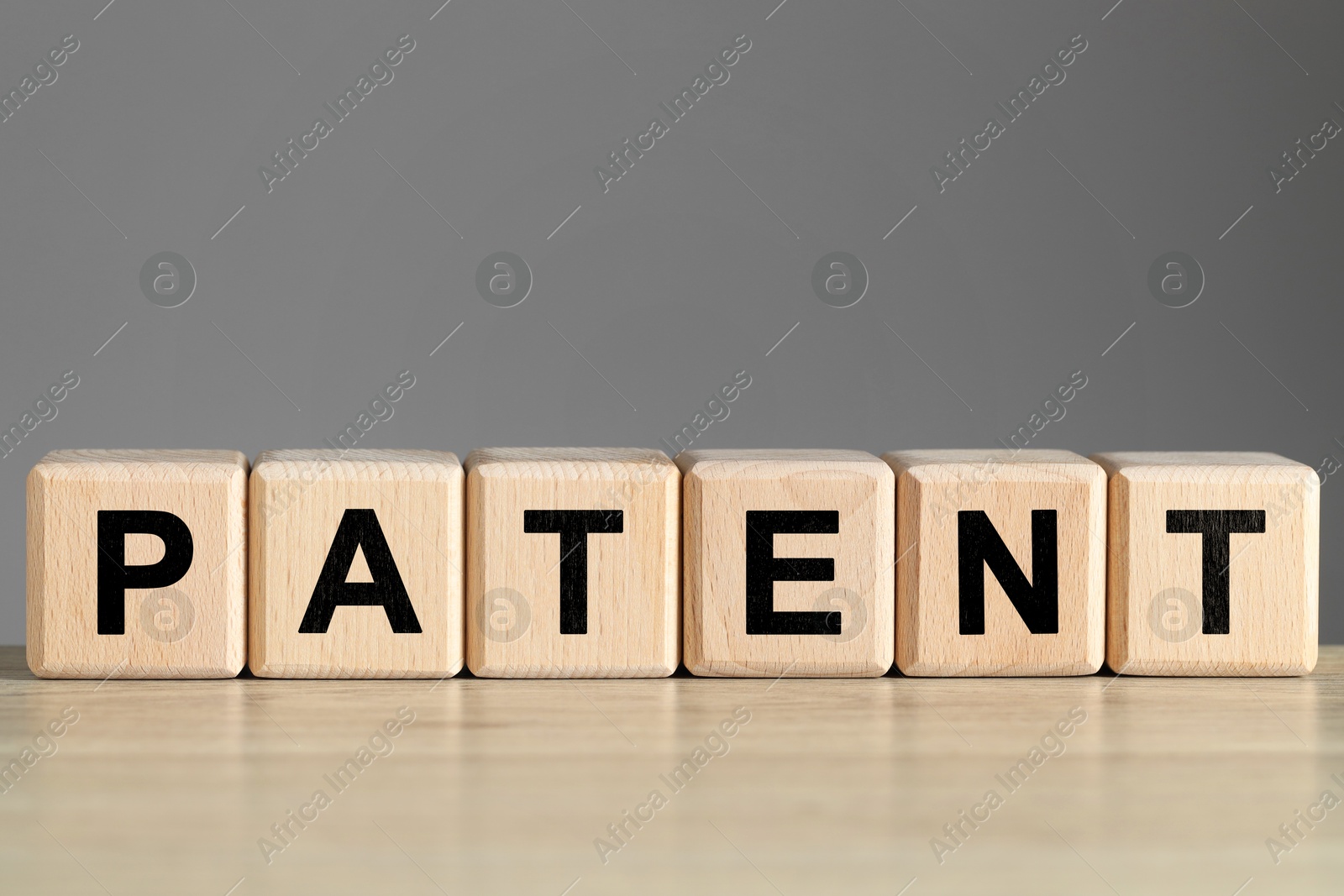 Image of License. Word Patent made of cubes with letters on wooden table