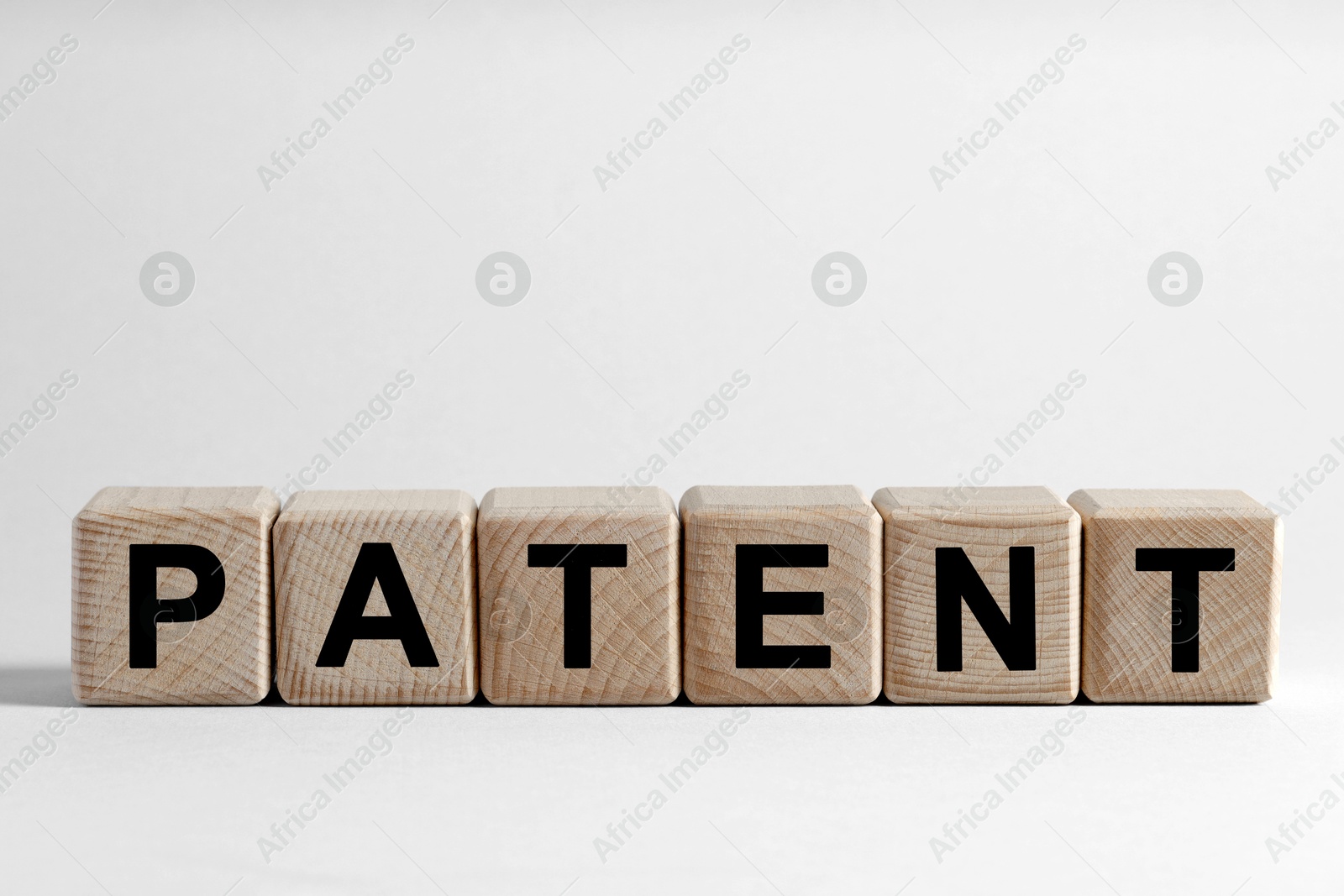 Image of License. Word Patent made of wooden cubes with letters on white background