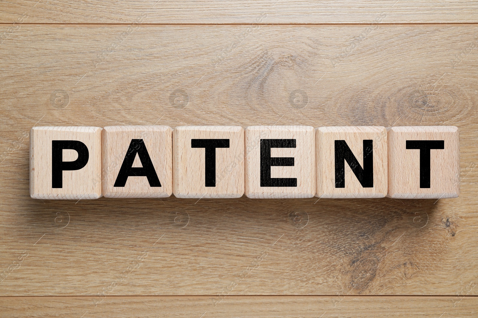 Image of License. Word Patent made of cubes with letters on wooden background, top view