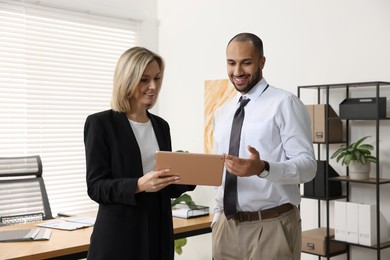 Photo of Coworkers with tablet working together in office