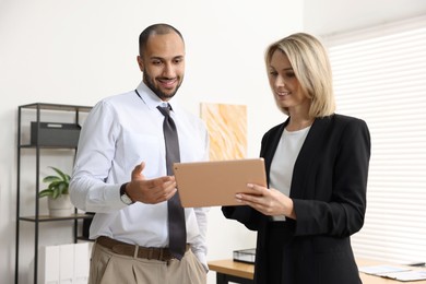 Photo of Coworkers with tablet working together in office