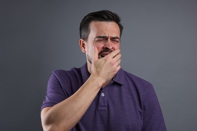 Photo of Portrait of sad man crying on grey background